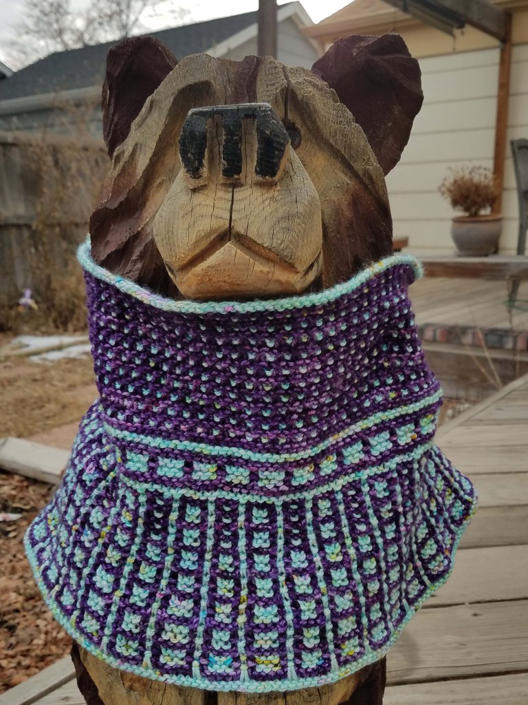 Cowl on wooden bear.