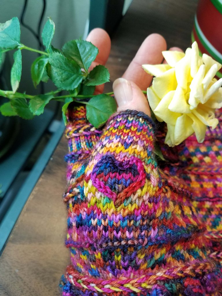 Embroidered heart on thumb of mitt.