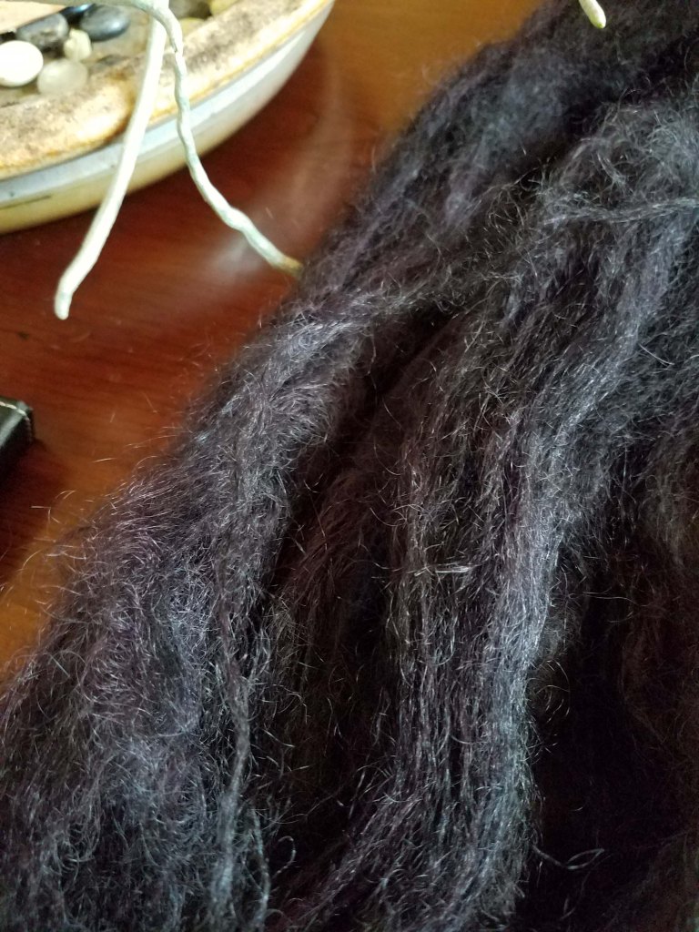 Mohair yarn dyed black.